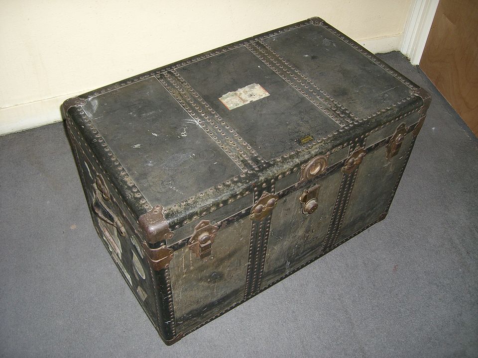 A large strong box with a lid, for storing or carrying things.
